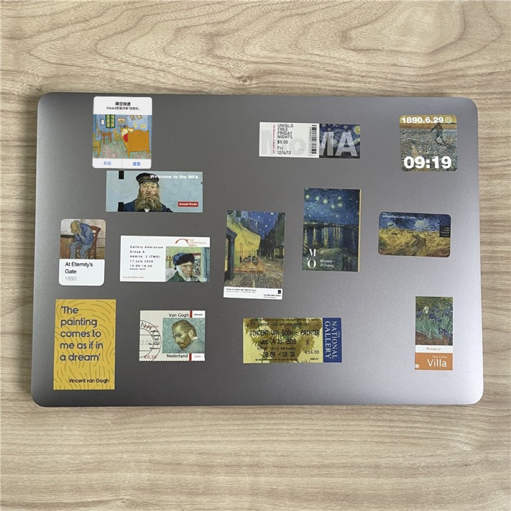 Laptop lid covered with printed fridge magnets of Van Gogh paintings