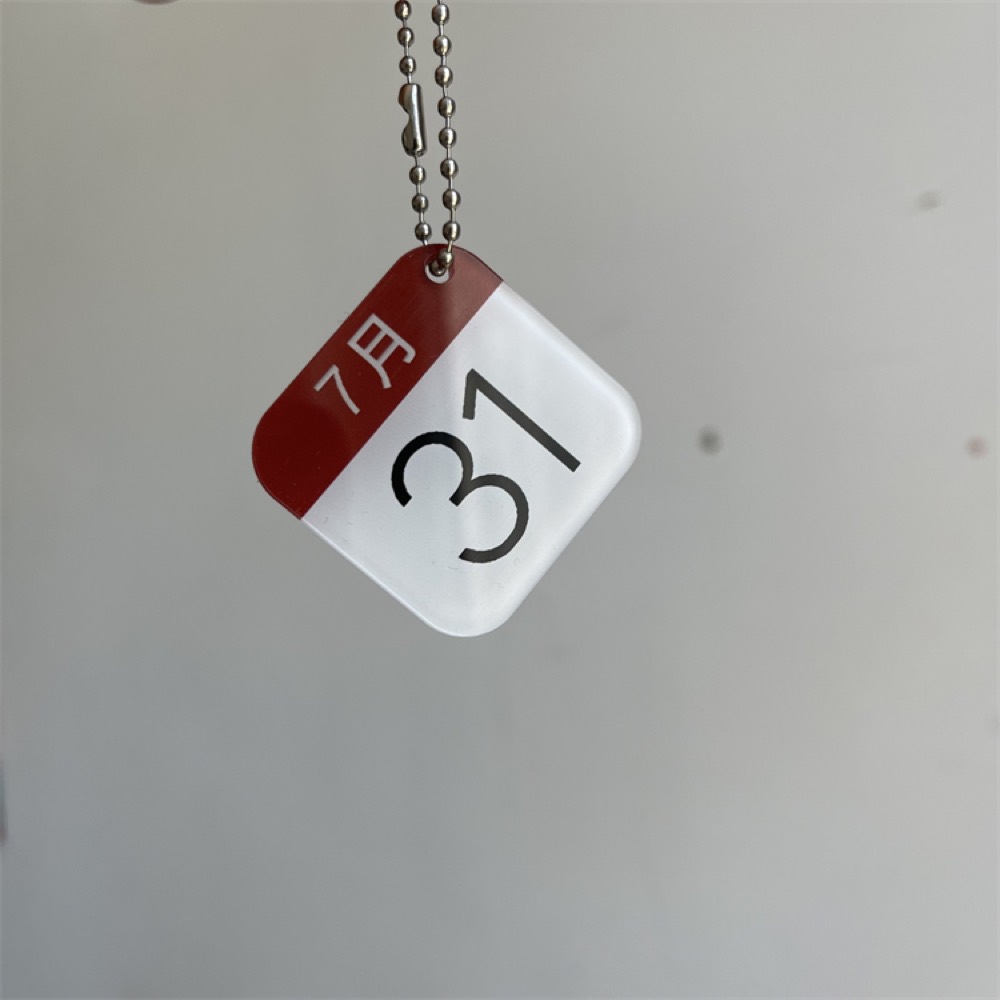 Square acrylic keychain with calendar artwork under an epoxy dome