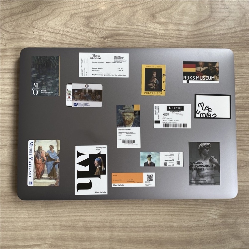 Laptop lid covered with museum-ticket fridge magnets